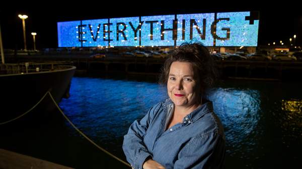 artist Fiona Jack in front of the light wall