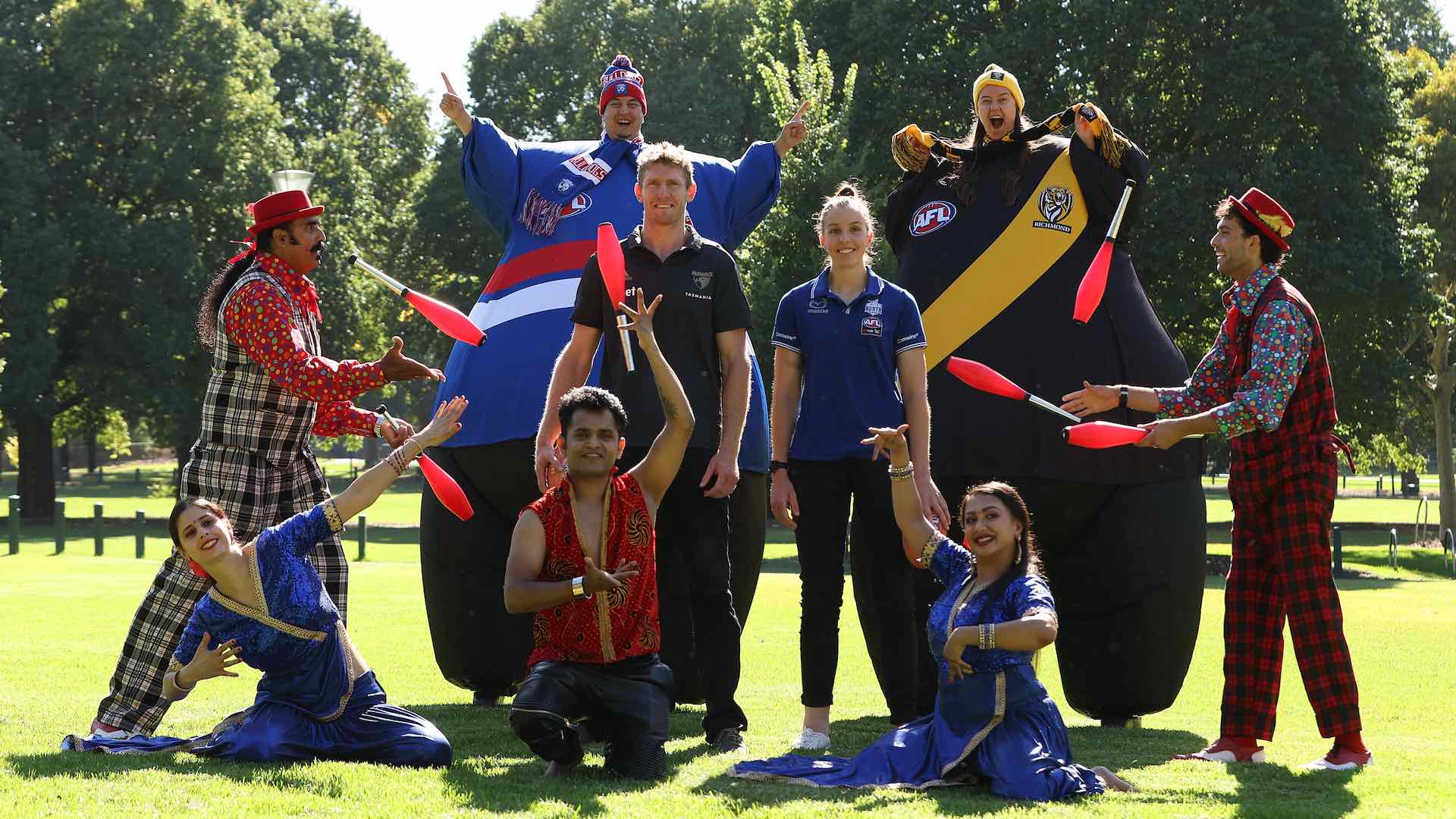Hawthorn captain Ben McEvoy and North Melbourne Tasmanian Kangaroos AFLW player Emma King pose with entertainers during the AFL Festival of Footy Launch at Yarra Park on March 03, 2022 in Melbourne, Australia.