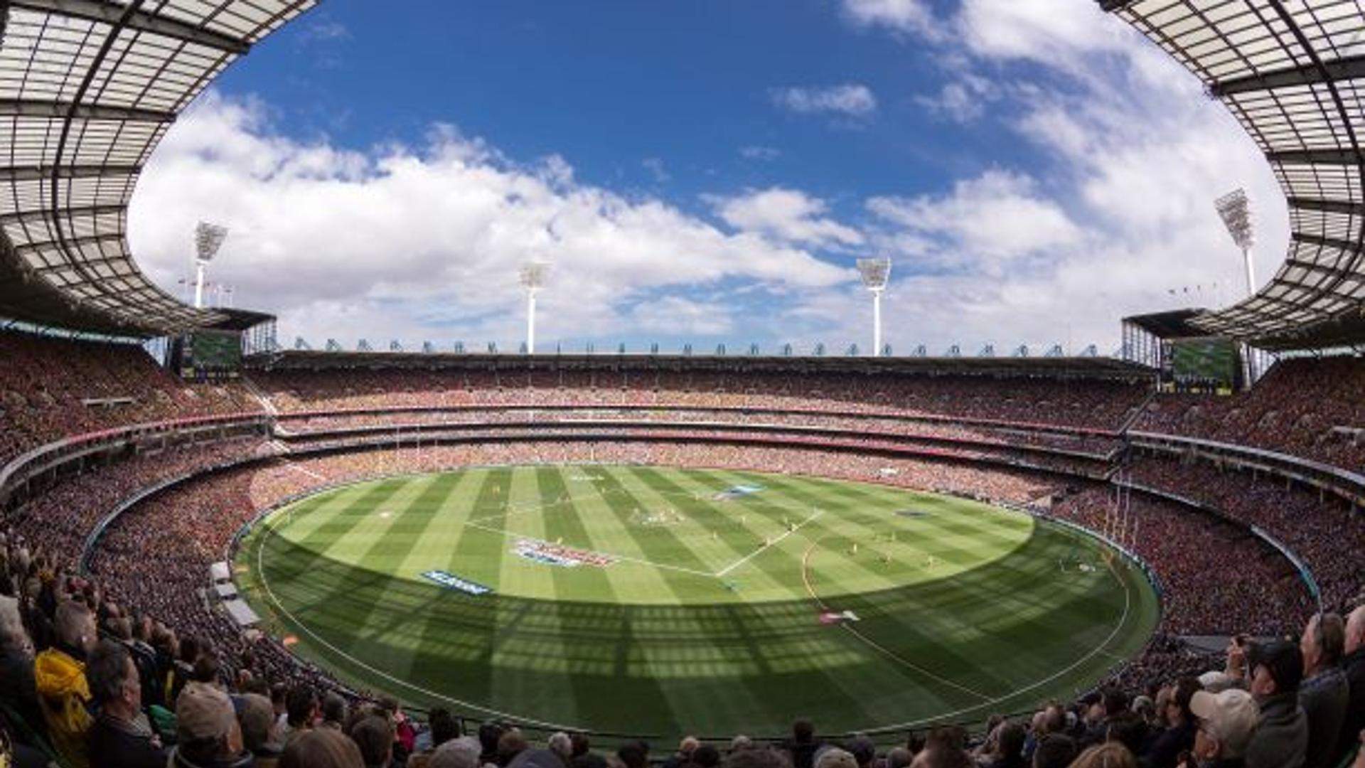 stadium crowd watching AFL game