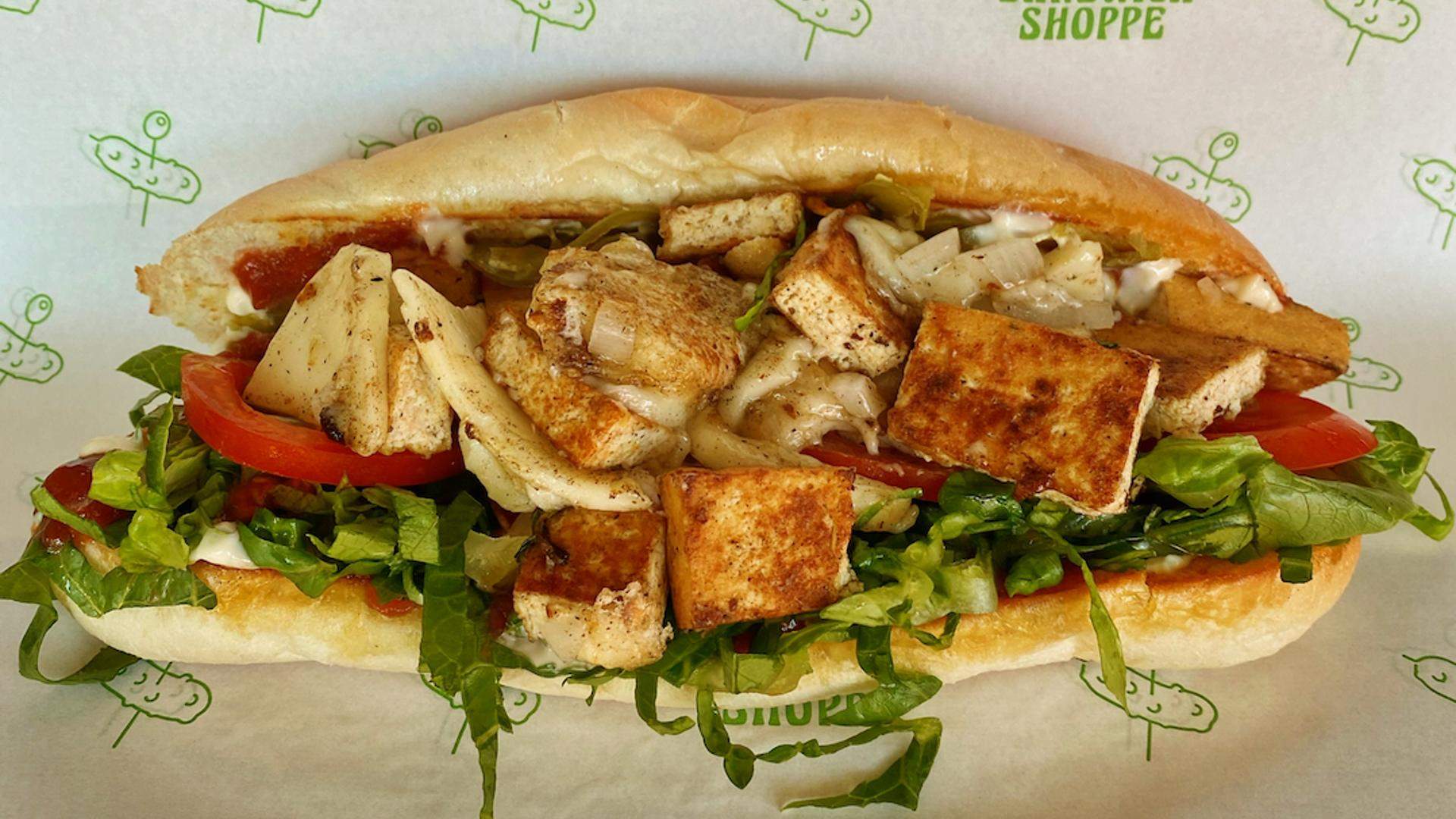 Closeup of a chop cheese sandwich with fried tofu