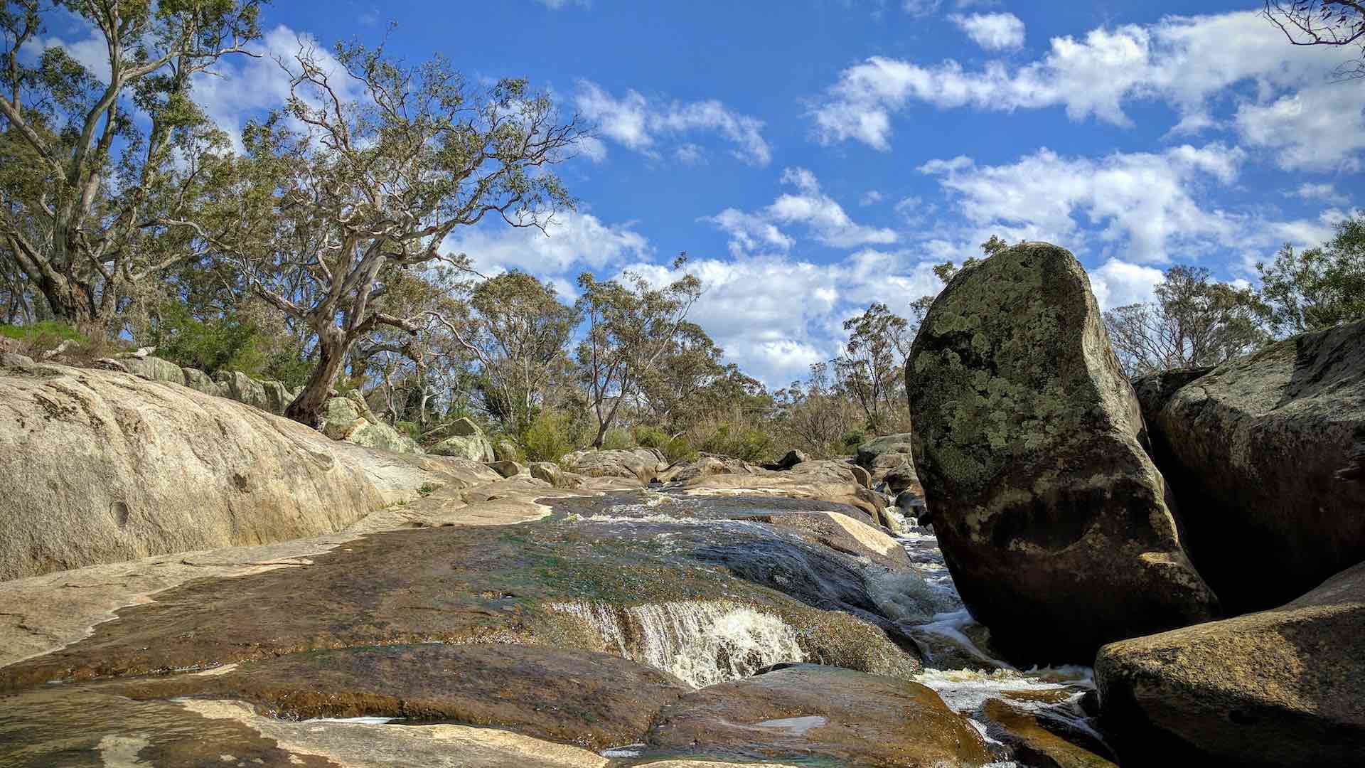 Metcalfe Cascades - river cascading over rock with blue sky