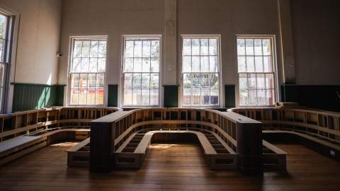 A row of booth seating with windows behind