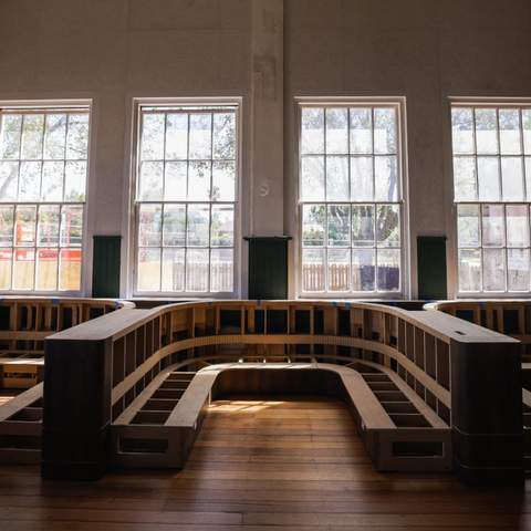 A row of booth seating with windows behind