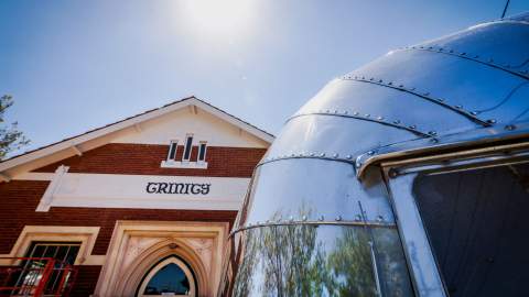 Upwards shot of Trinity's facade and the Airstream beside it