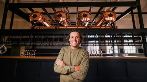 Publican Matt Nikakis standing in front of a bar