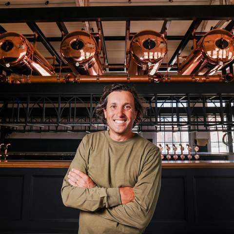 Publican Matt Nikakis standing in front of a bar