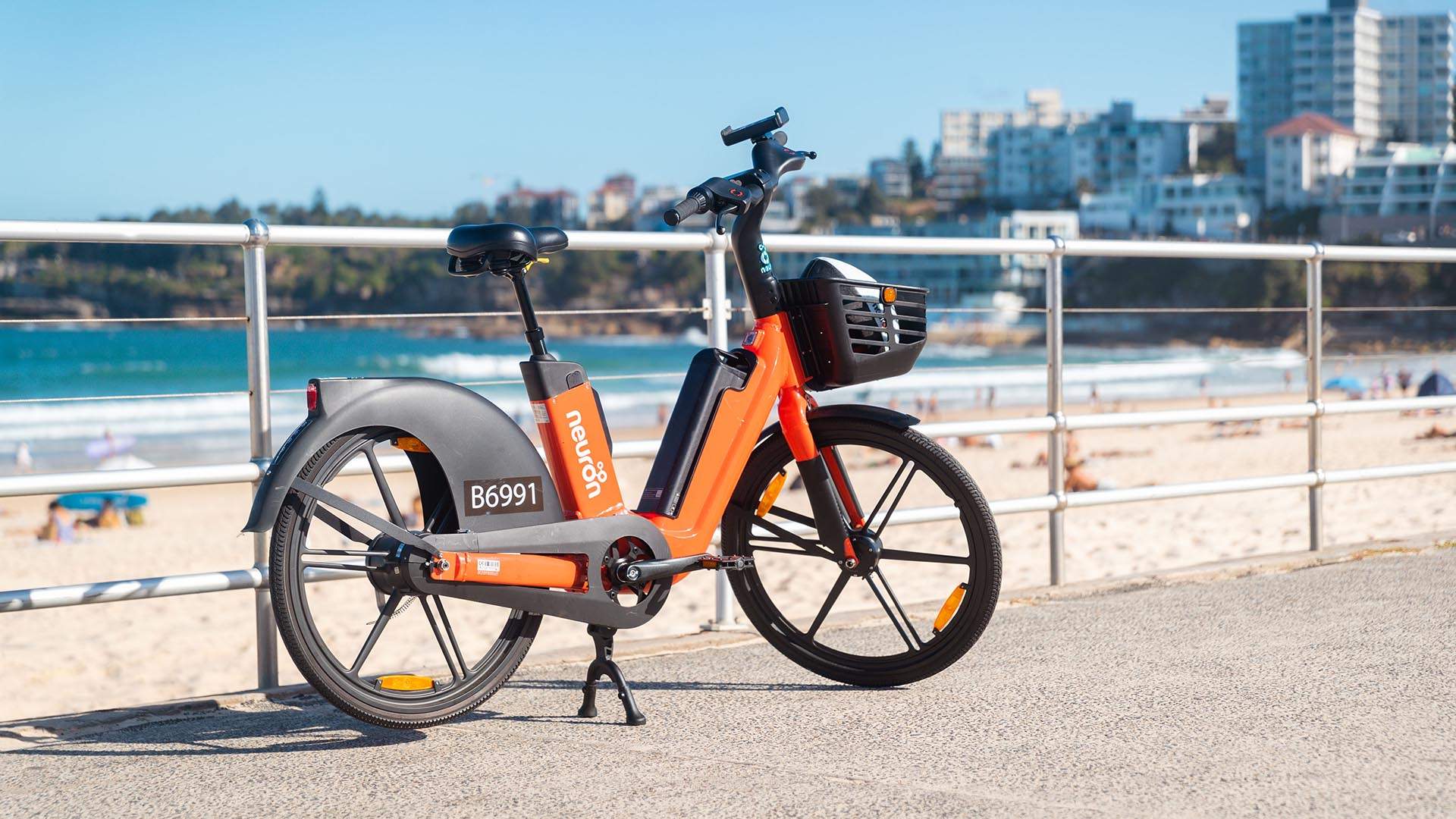 You Can Now Ride Around the CBD, Bondi and Coogee On Neuron Mobility's Orange-Hued E-Bikes