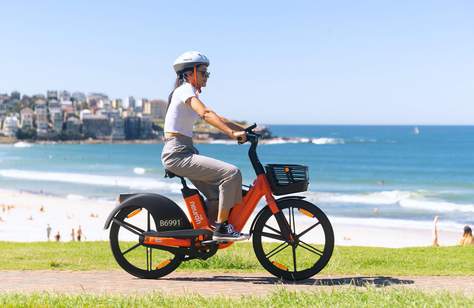 You Can Now Ride Around the CBD, Bondi and Coogee On Neuron Mobility's Orange-Hued E-Bikes