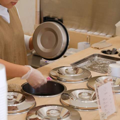 Worker scooping gelato out at Hareruya Pantry.