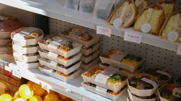 A shelf filled with pre packaged lunches at Hareruya Pantry