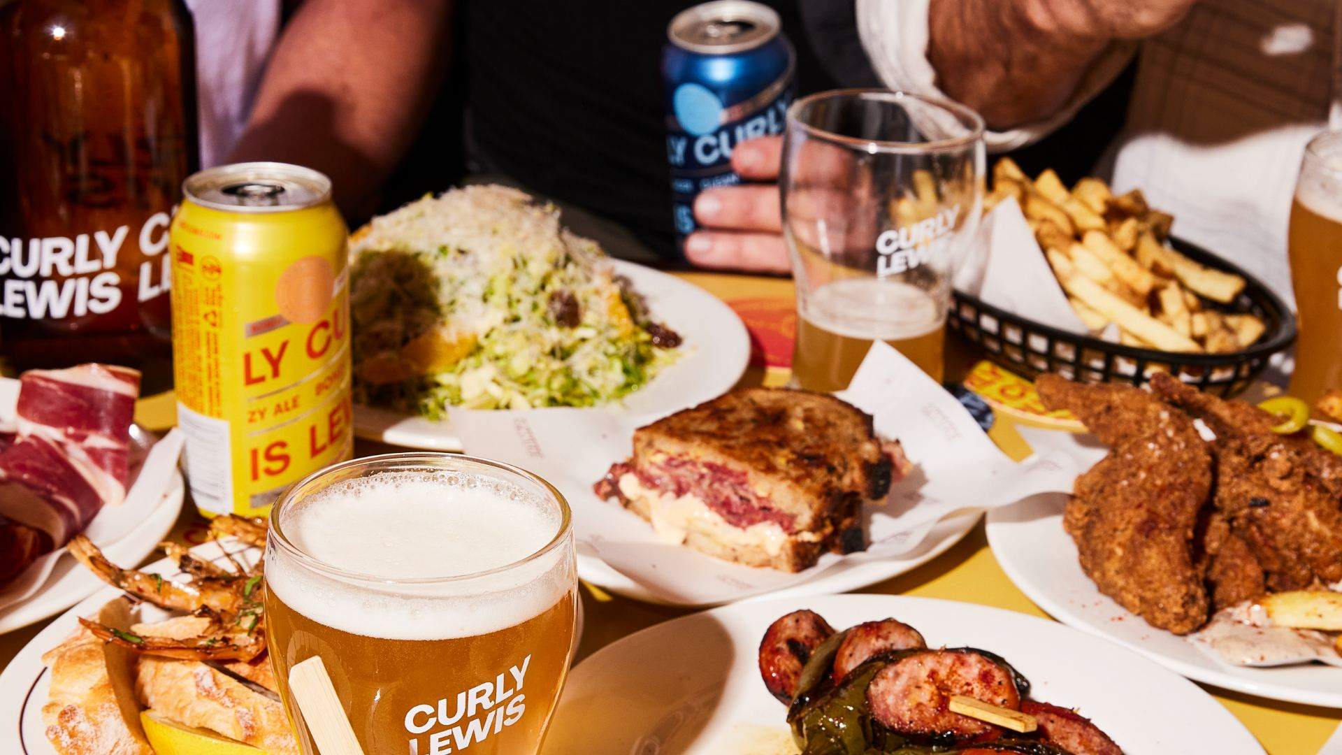 A table full of beers and food at Curly Lewis Brewing Co in Bondi, Sydney.