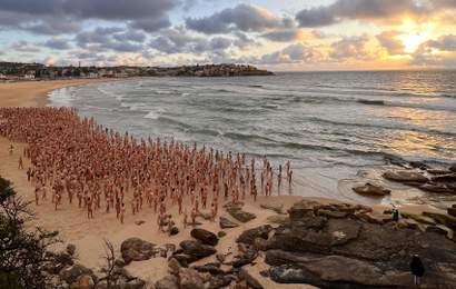 Background image for Bondi Briefly Turned Into a Nude Beach for Photographer Spencer Tunick's Latest Mass Installation