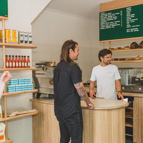 Busy scene of customers in Good Ways Deli shop.