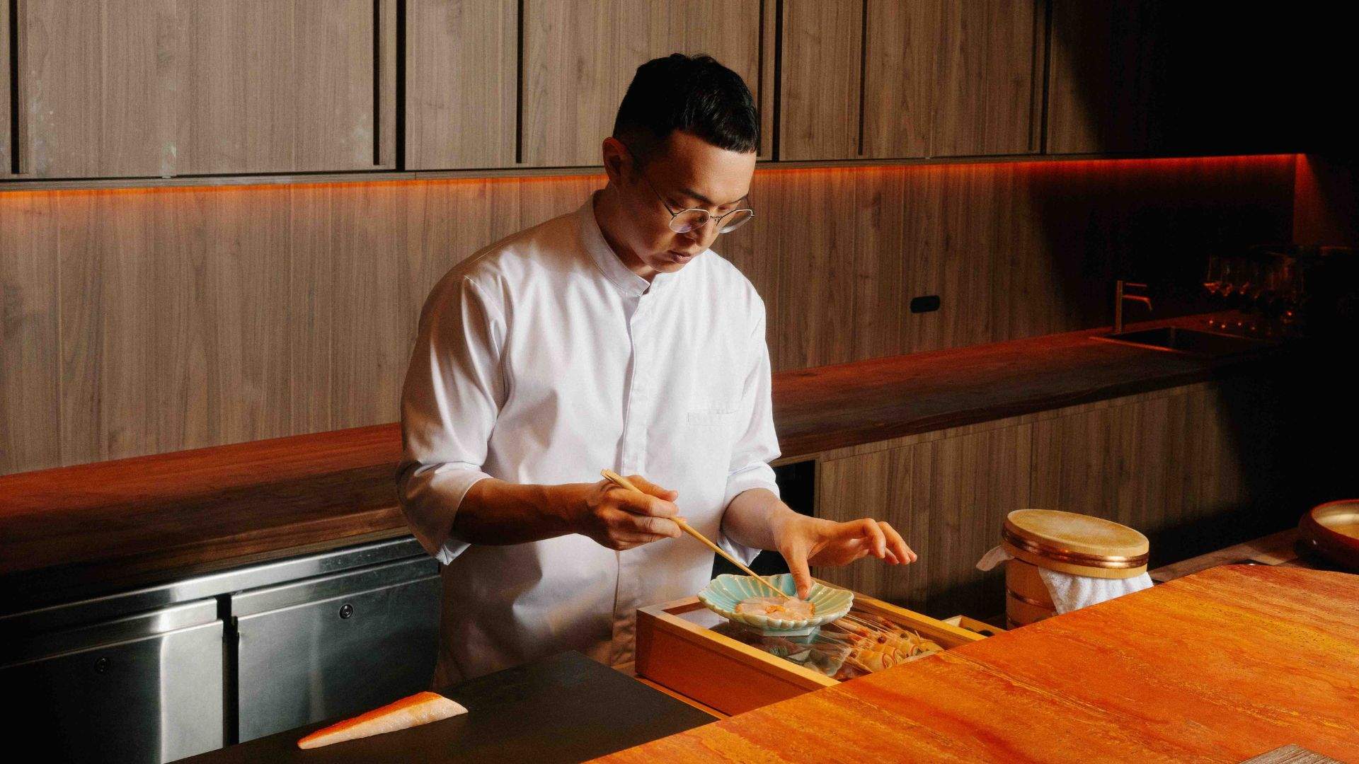 Chef Alex Yu carfelly plating dishes at Yugen Dining in Melbourne. Home to some of the best omakase in Melbourne.