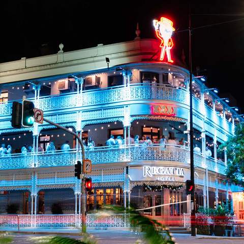 A view of the Regatta Hotel lit up at night - one of the best sports bars in Brisbane