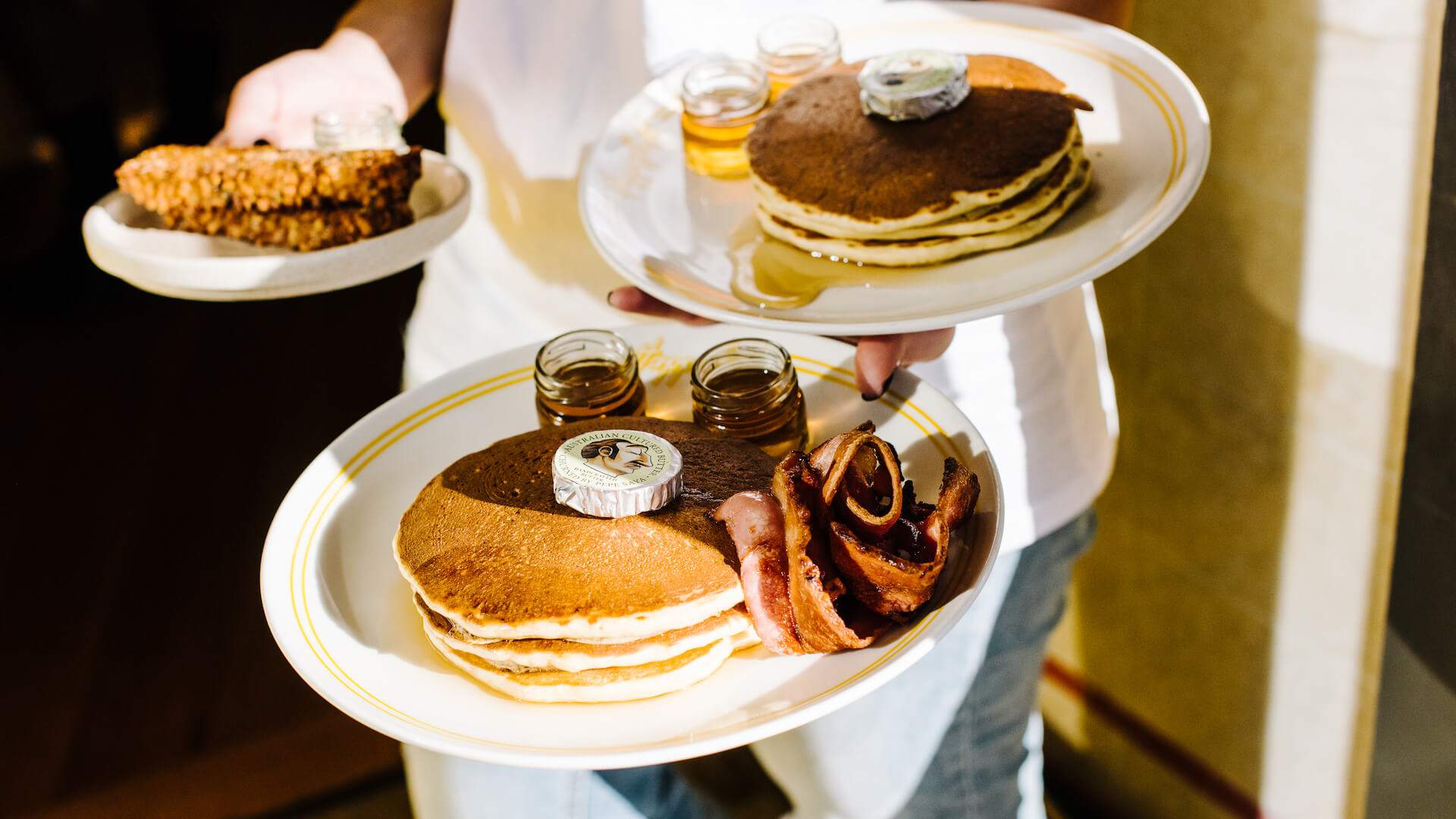 Plates of pancakes at happyfield - home to some of the best breakfast in Sydney.