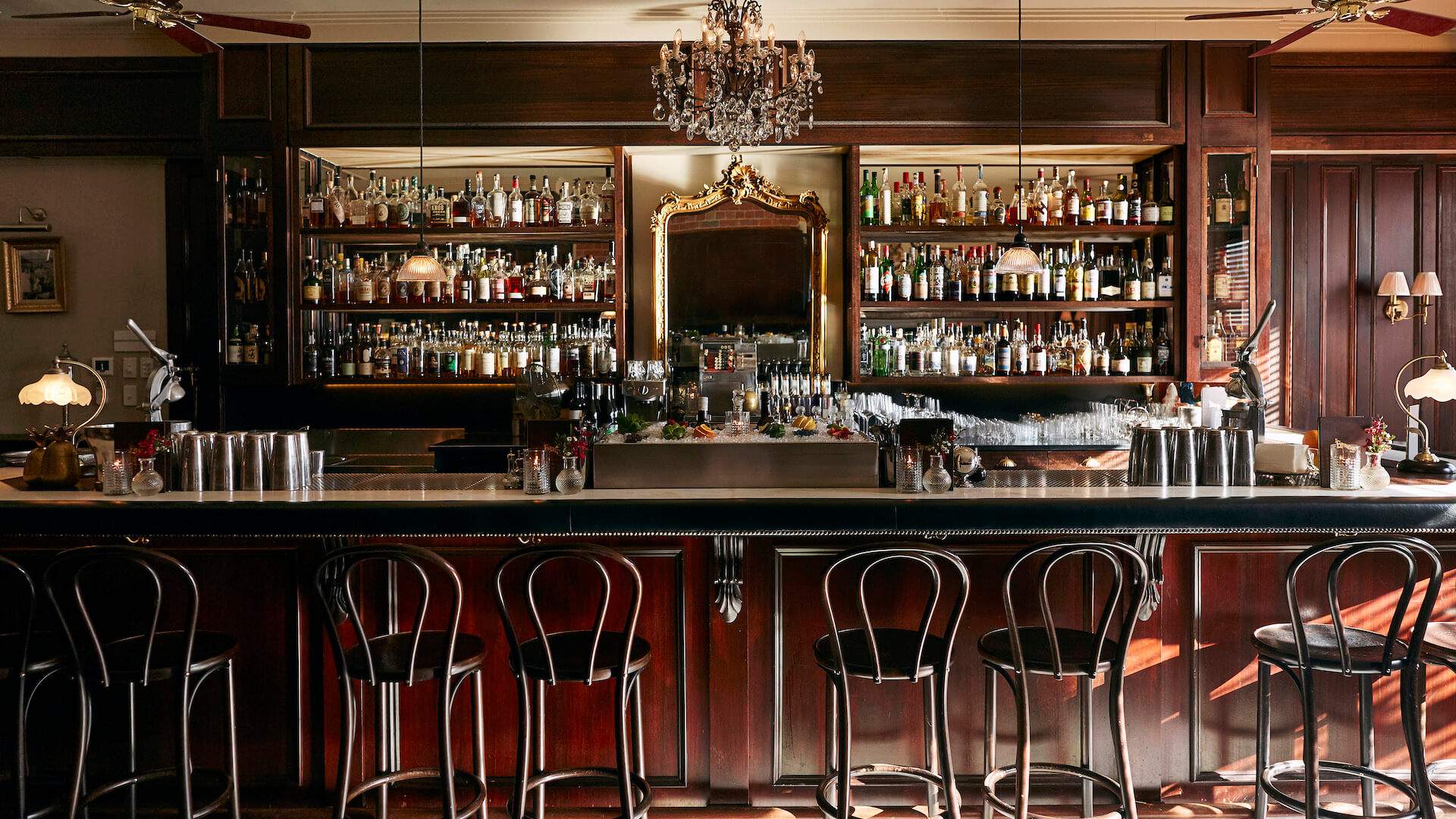 an empty bar with stools at the everleigh- one of the best melbourne bars