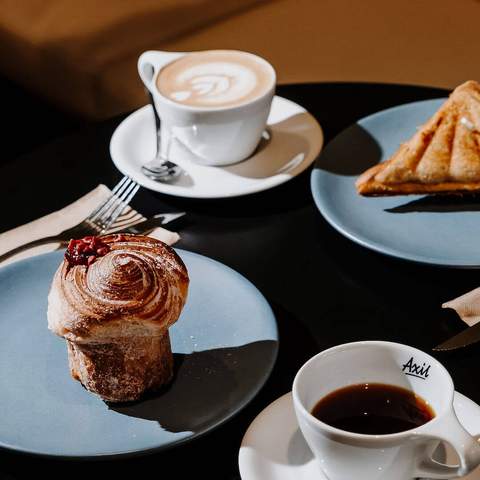 table with coffee and cakes at Axil Coffee Roasters, Melbourne coffee