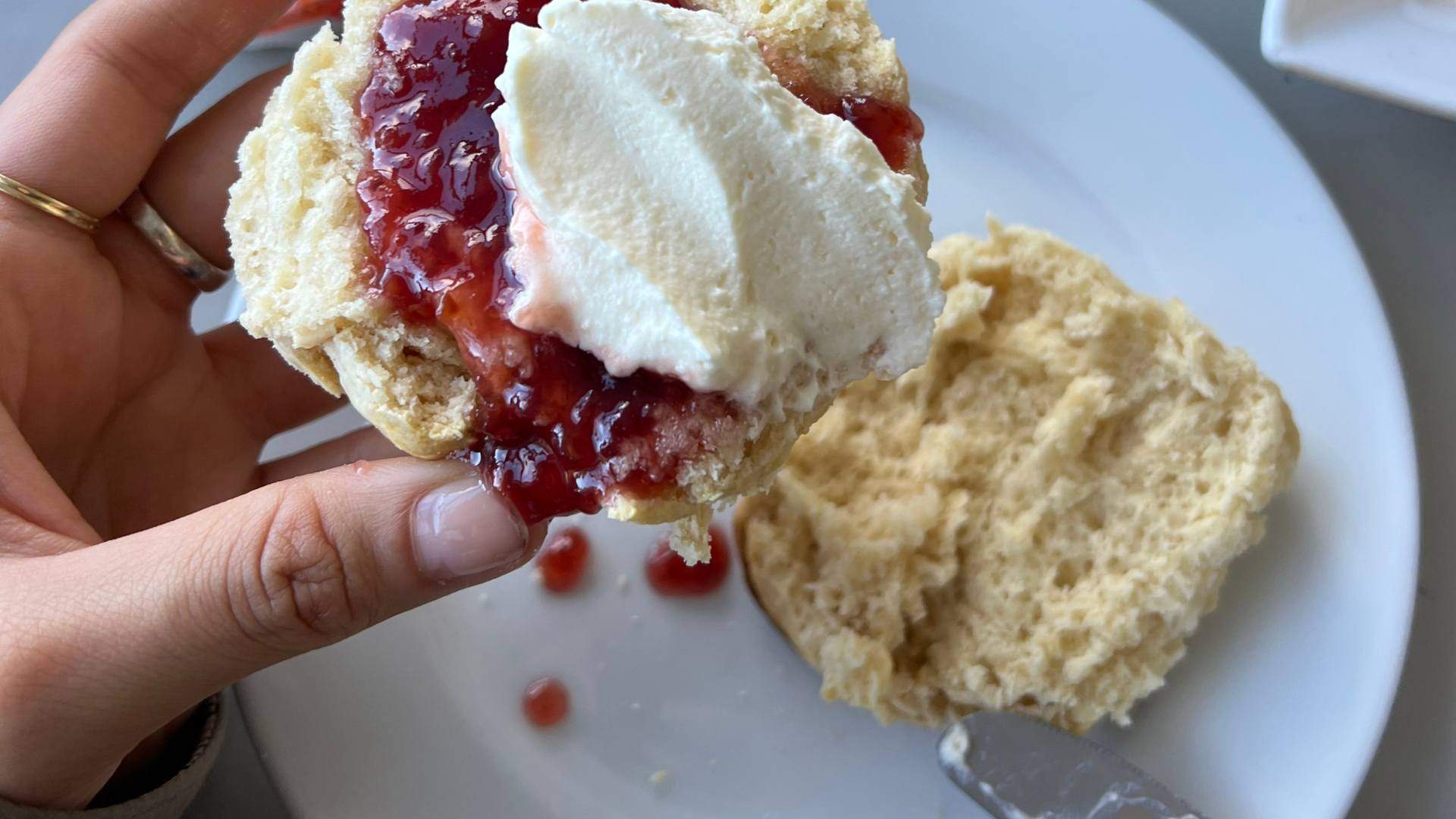 A fresh scone covered with a layer of strawberry jam and a dollop of cream from the Lightkeepers Cafe, the cafe at the Cape Otway Lightstation in Victoria