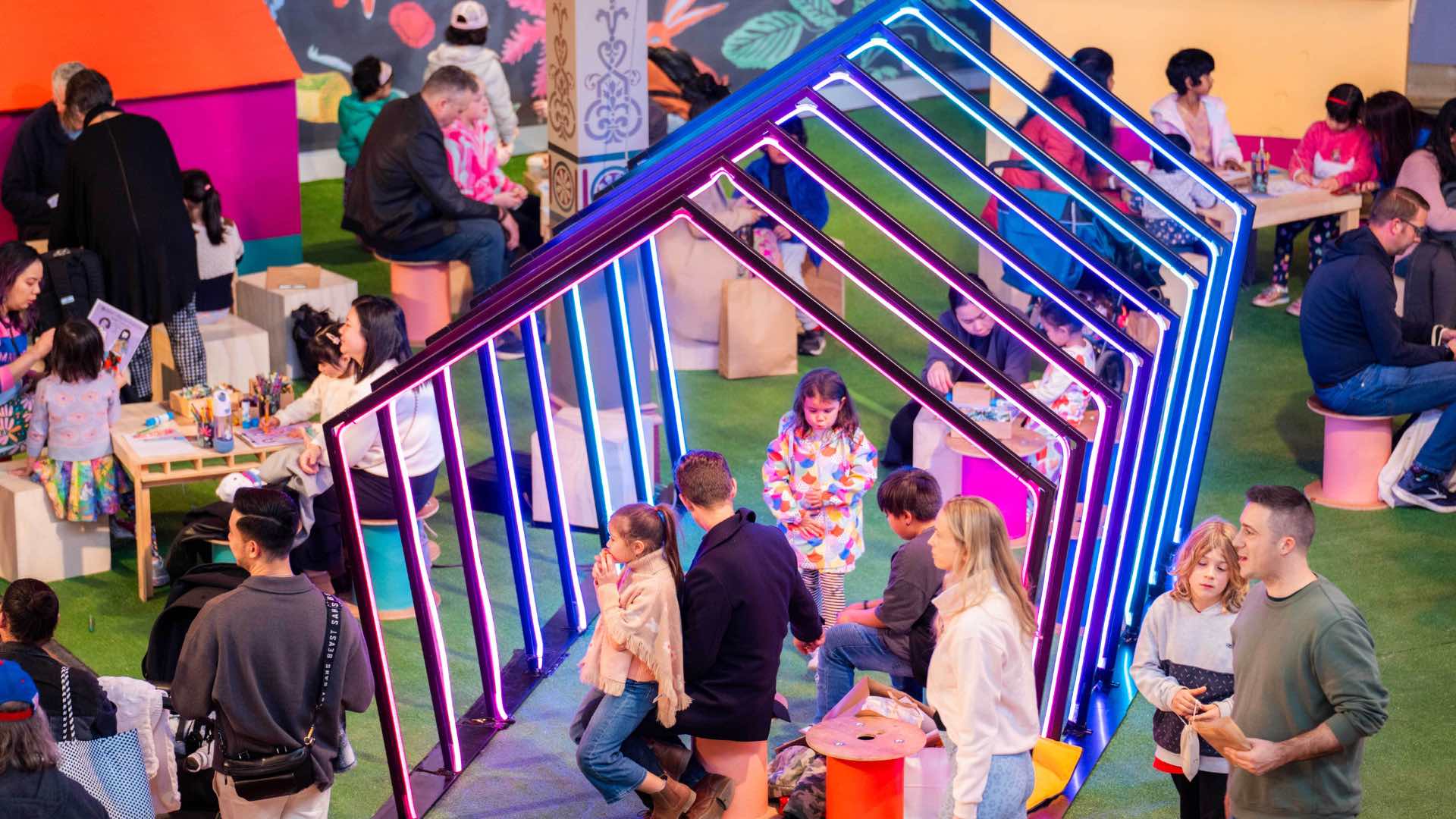 Photo of families with children playing under a light installation at The Big Design Market.