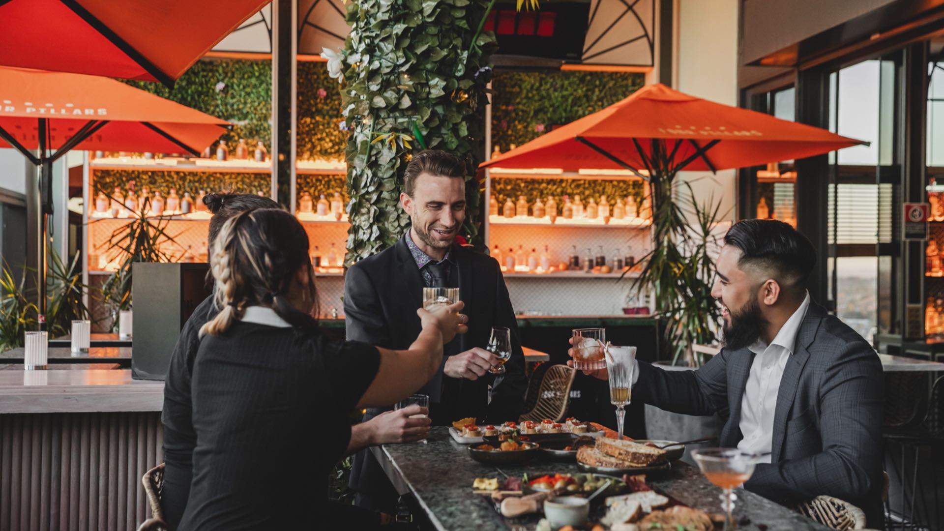 Photo of four friends having drinks and appetisers at Nick & Nora's bar.