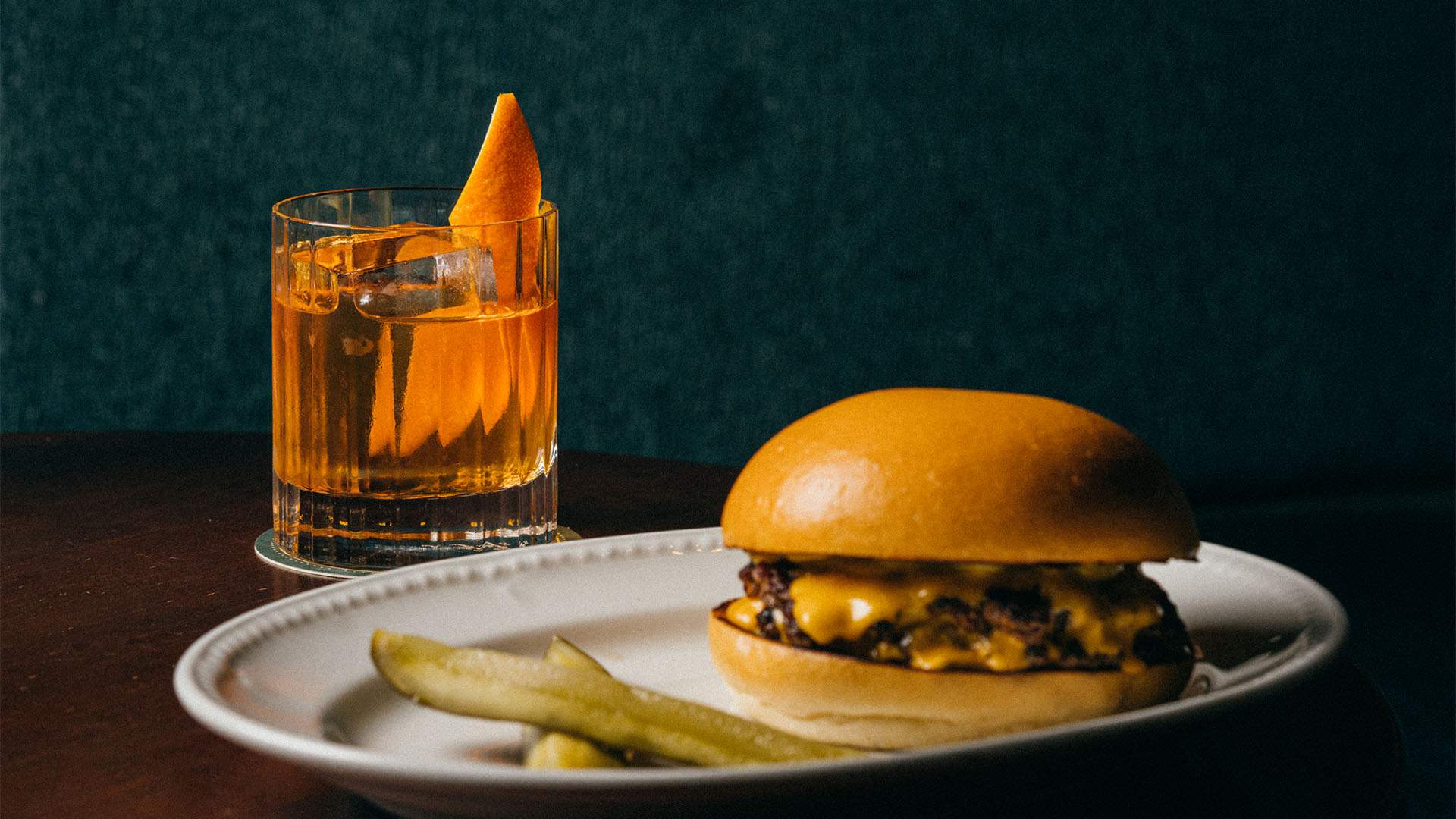 A burger with a cocktail and some chips at The Gidley - home to one of the best burgers in Sydney