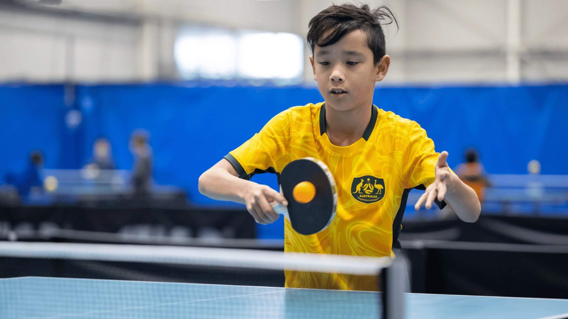 A boy playing table tennis.