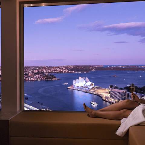 A woman looking out at Sydney Harbour at the Shangri-La Sydney hotel.