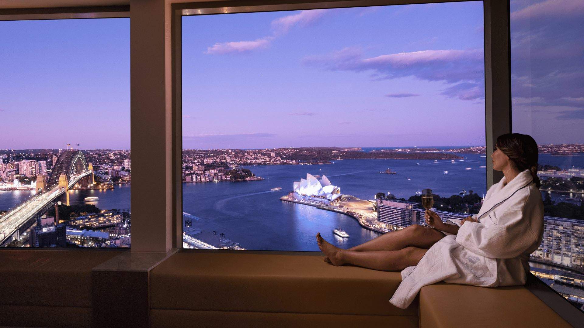 A woman looking out at Sydney Harbour at the Shangri-La Sydney hotel.