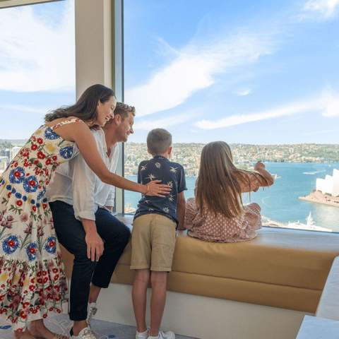 A family looking out at Sydney Harbour at the Shangri-La Sydney hotel.