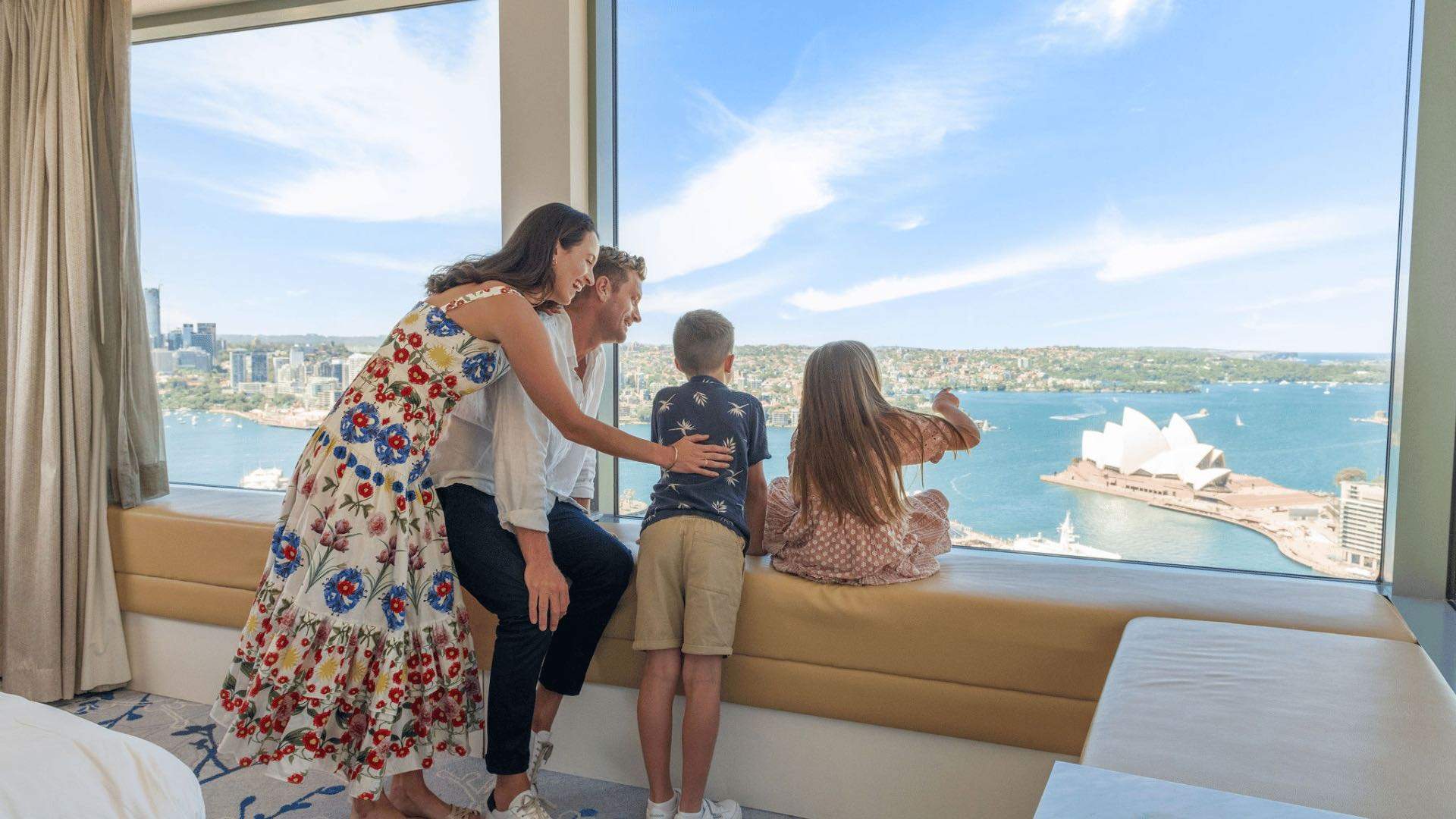A family looking out at Sydney Harbour at the Shangri-La Sydney hotel.
