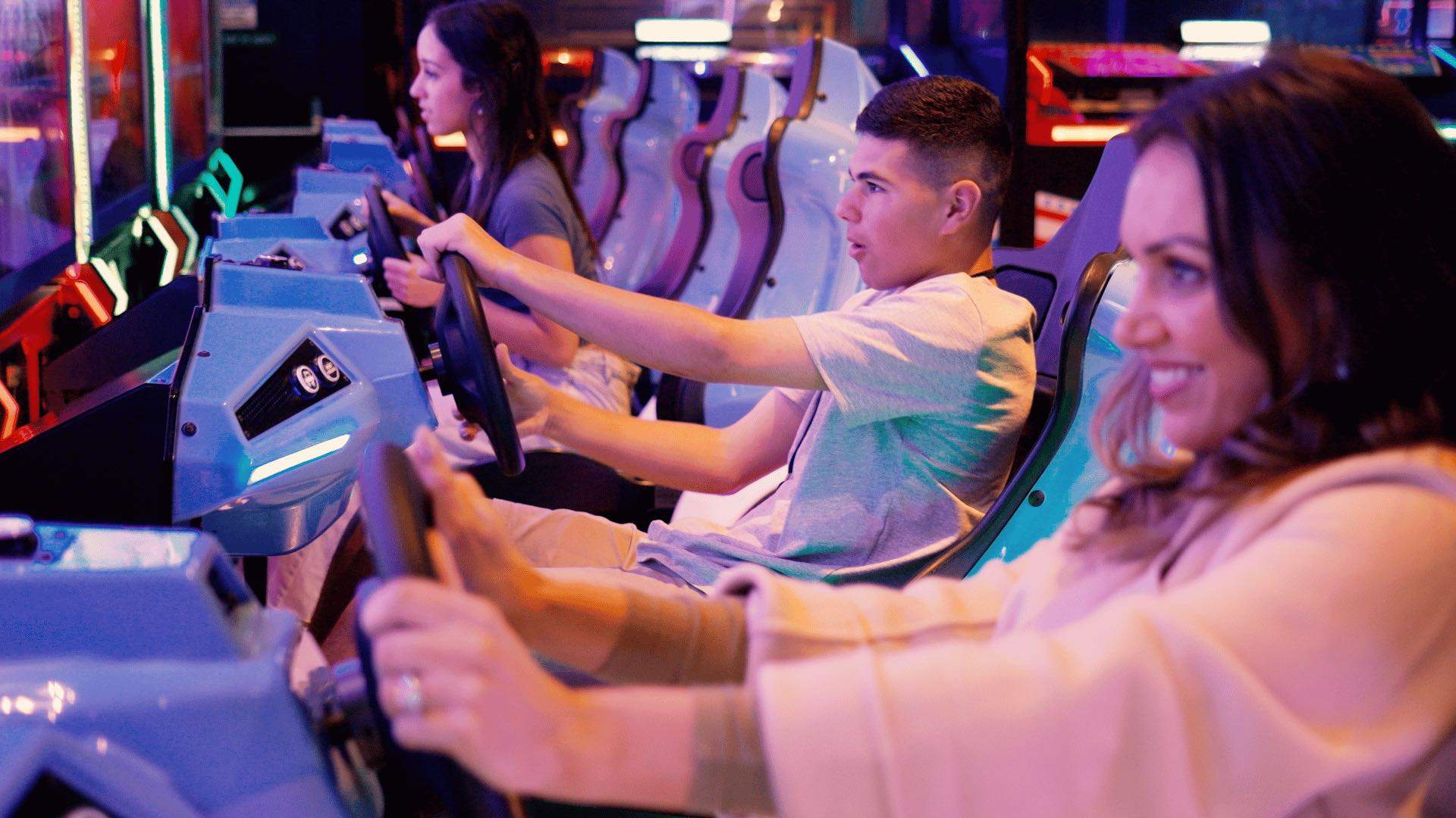 A group playing a driving game at The Funderdome.