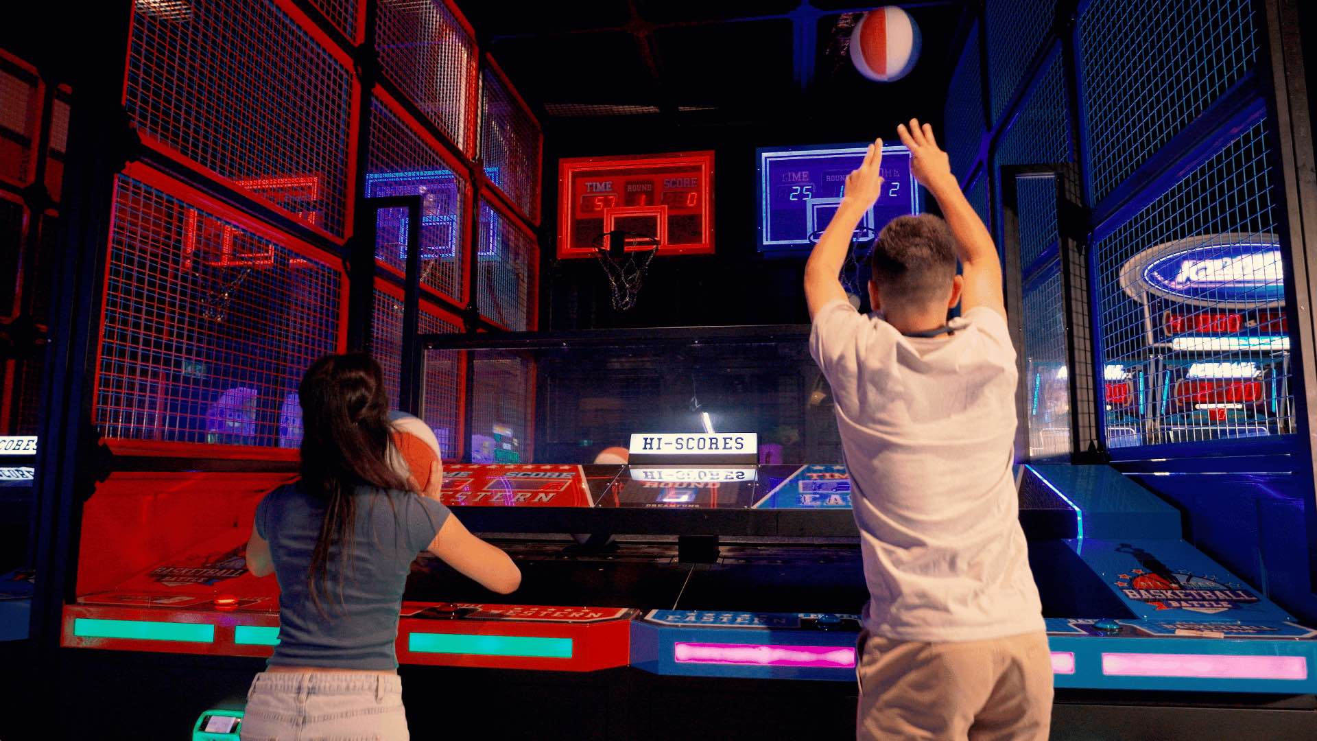 Two people playing a basketball game at The Funderdome.