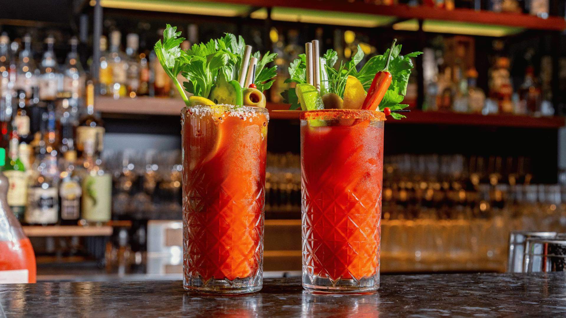 Two Bloody Marys at a bar.