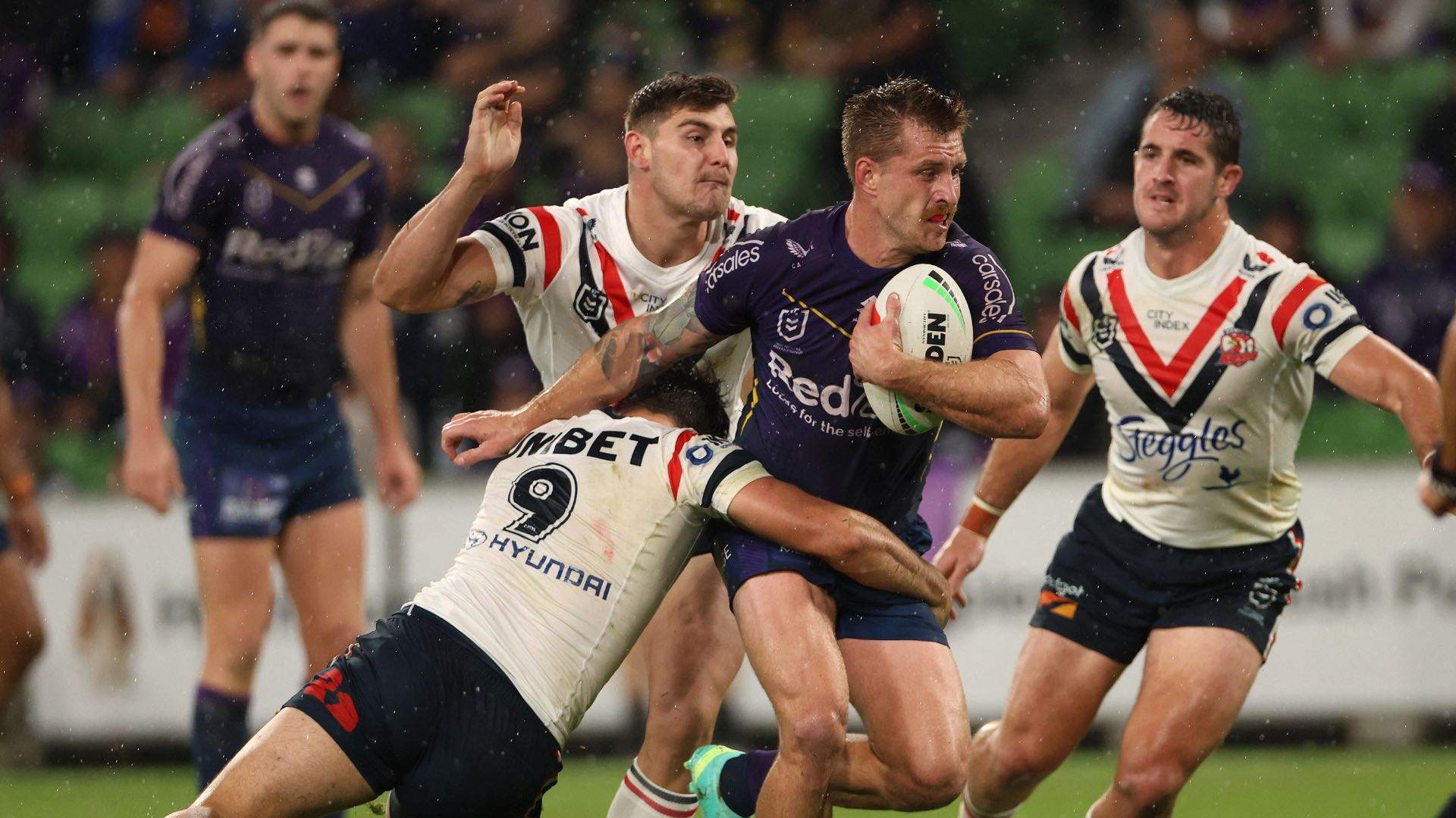 A photo of Roosters players at an NRL game.