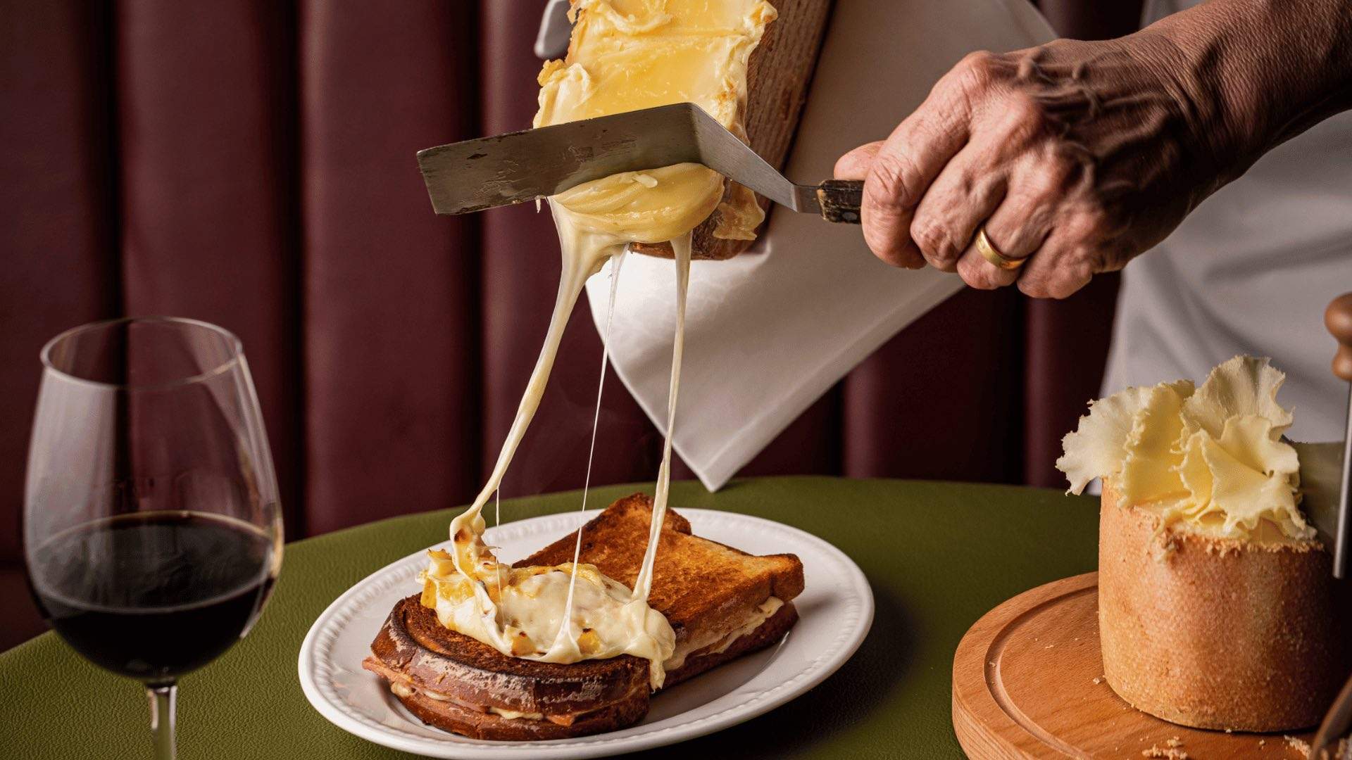 Photo of raclette cheese on a toasted sandwich.