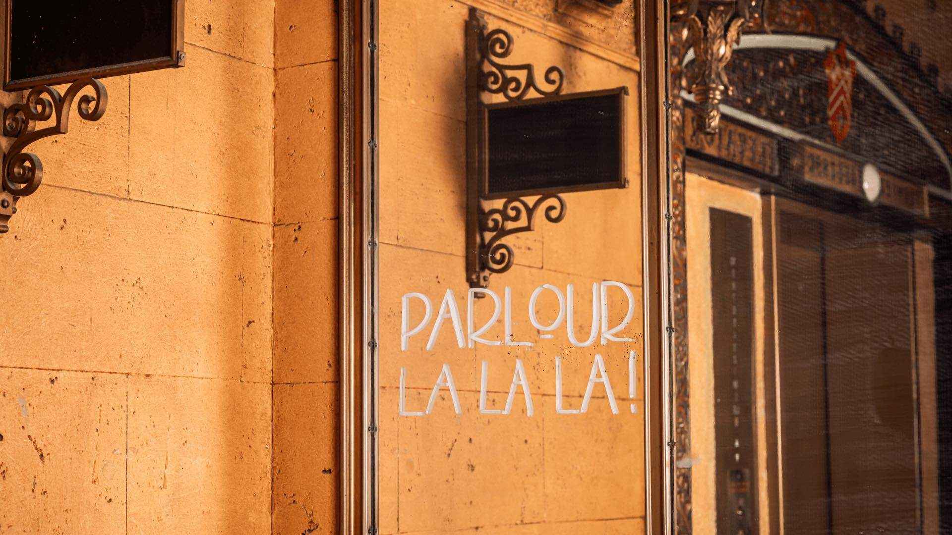 Photo of a mirror with "Parlour La La La" written on it.