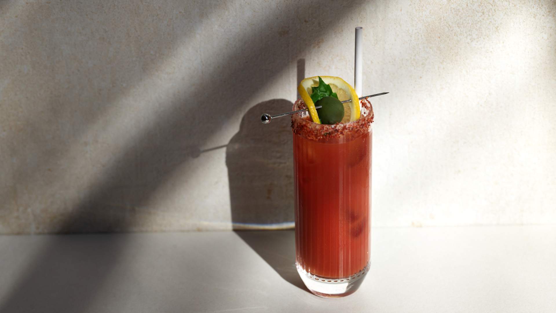 Poetica's take on a bloody mary, the Dawn, casts a shadow on a white wall