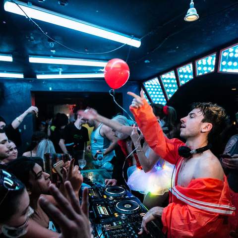 Dancers are packed into the neon light-lit rave cave at Sydney's World Bar in the 2010s