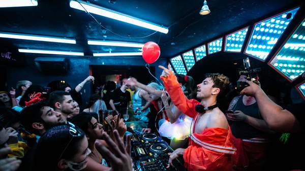 Dancers are packed into the neon light-lit rave cave at Sydney's World Bar in the 2010s