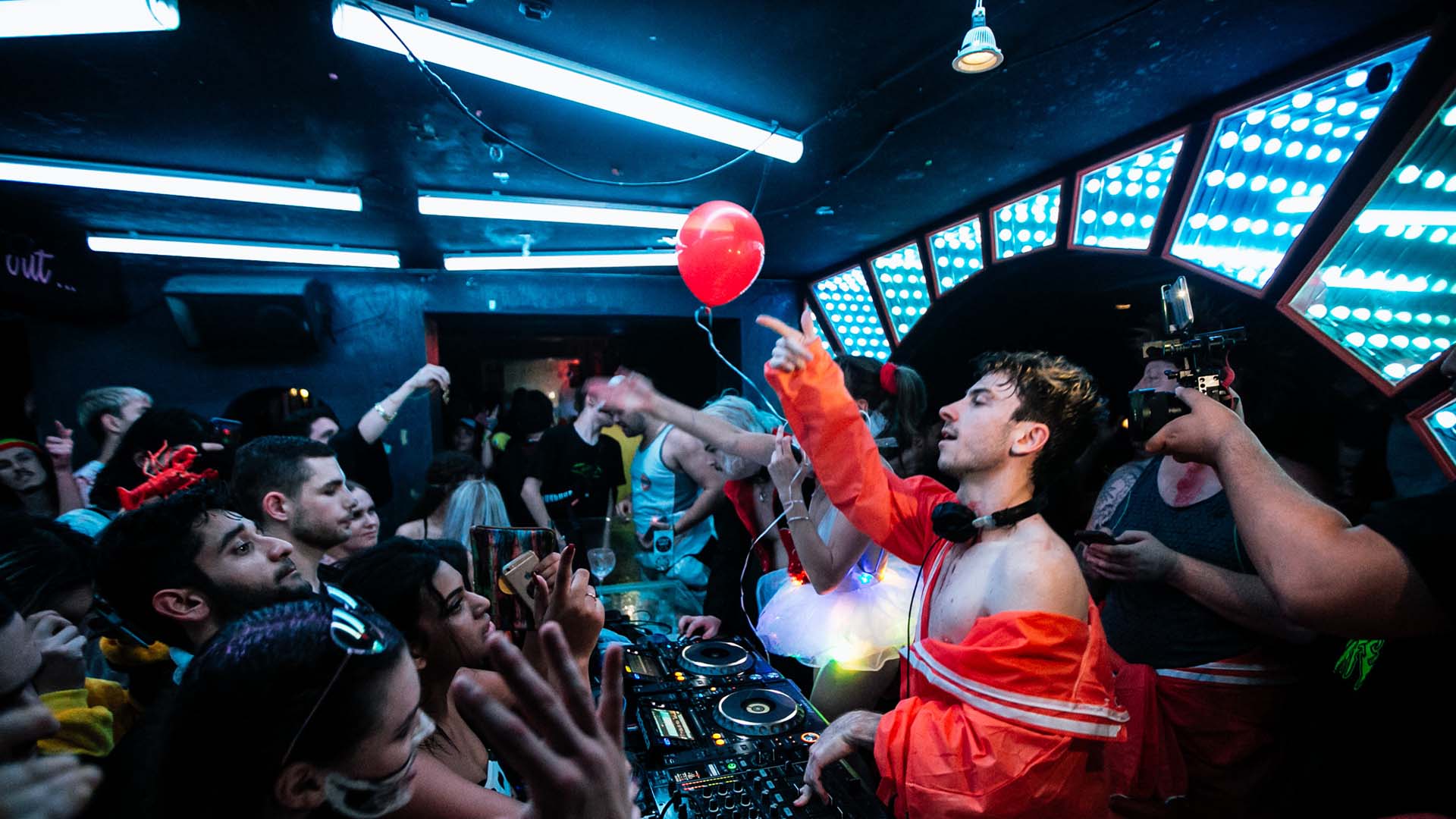 Dancers are packed into the neon light-lit rave cave at Sydney's World Bar in the 2010s