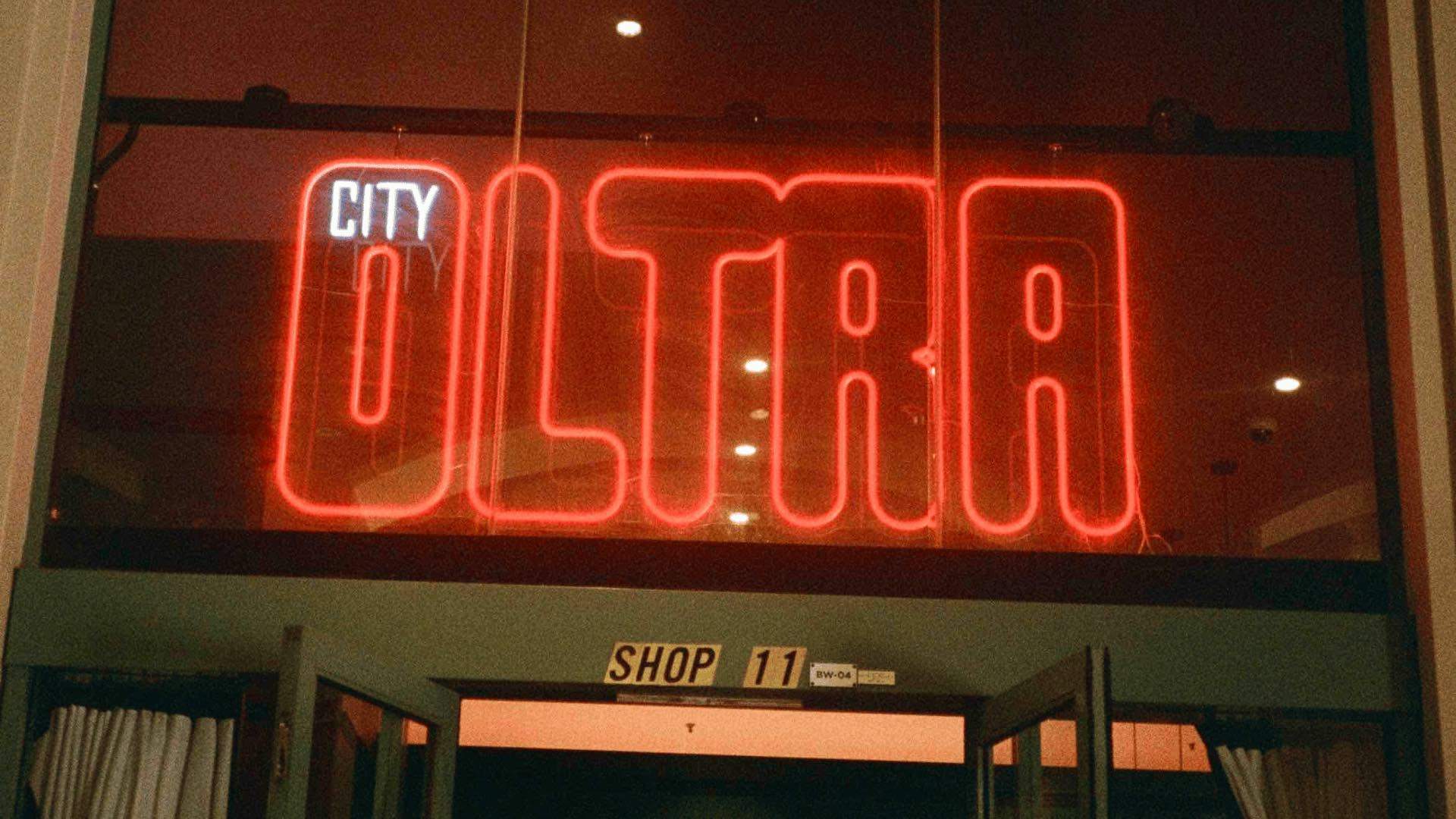 A photo of the neon sign at the entrance of City Oltra.
