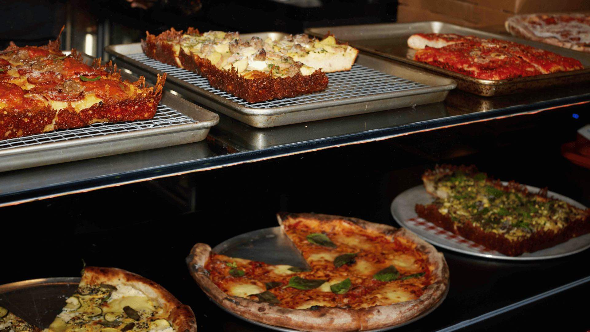 Four square and round pizzas on display at City Oltra.