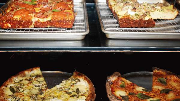 Four square and round pizzas on display at City Oltra.