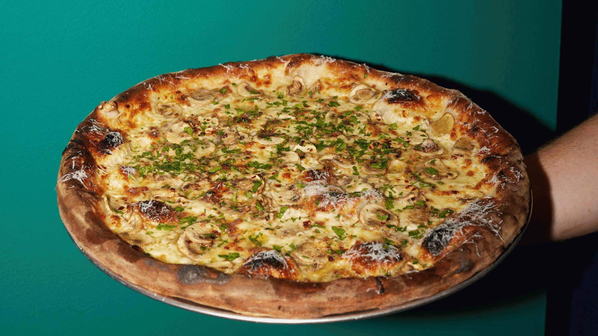 A large pizza with mushrooms from City Oltra.