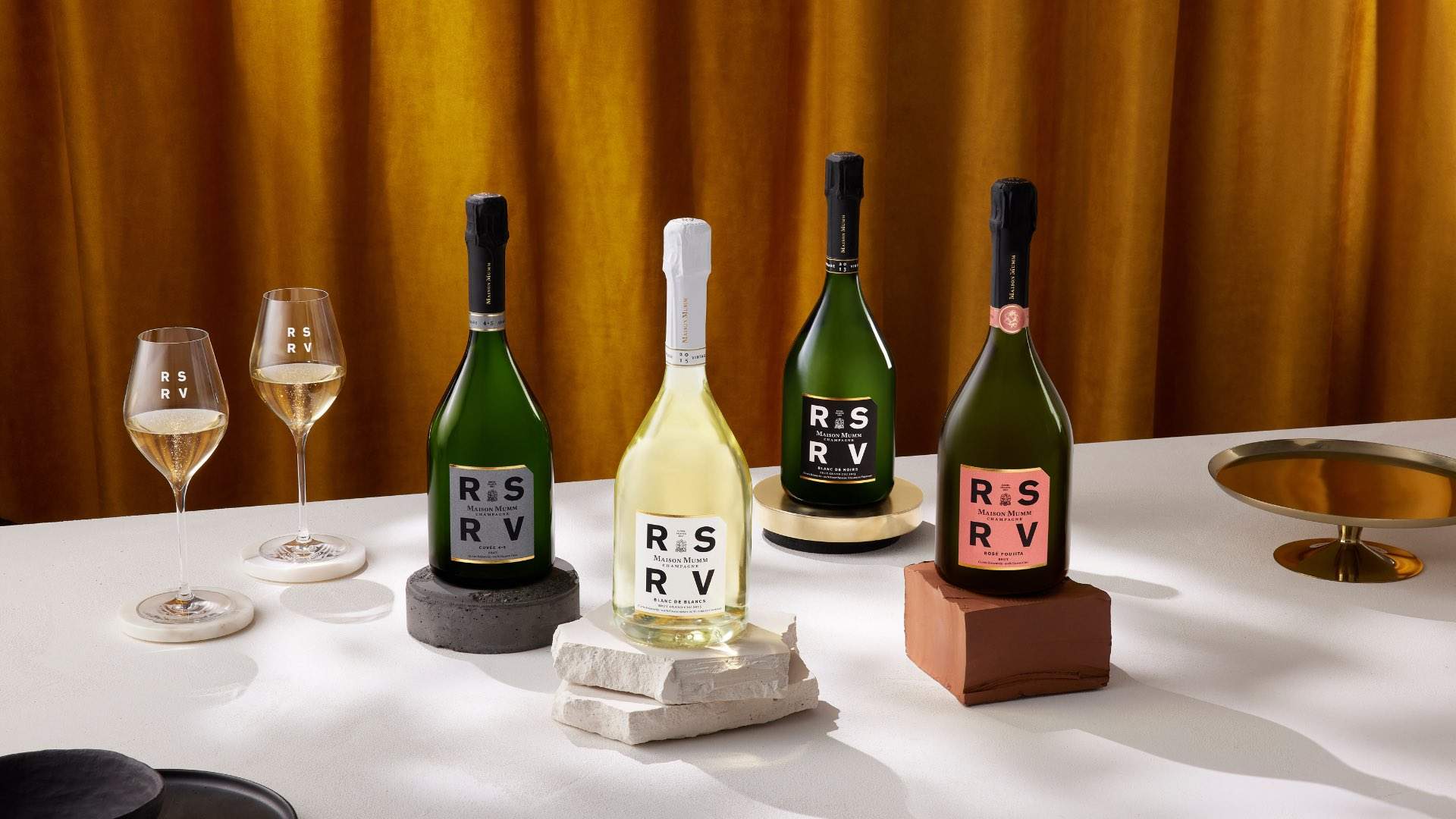 Four bottles of Maison Mumm's RSRV wines on a table.