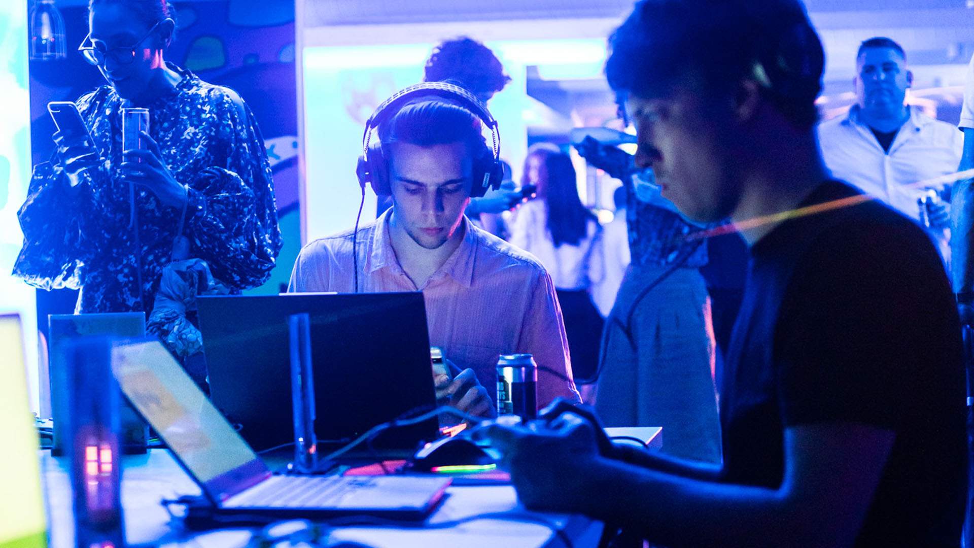 Two men sit at laptops playing game demos at SXSW Sydney