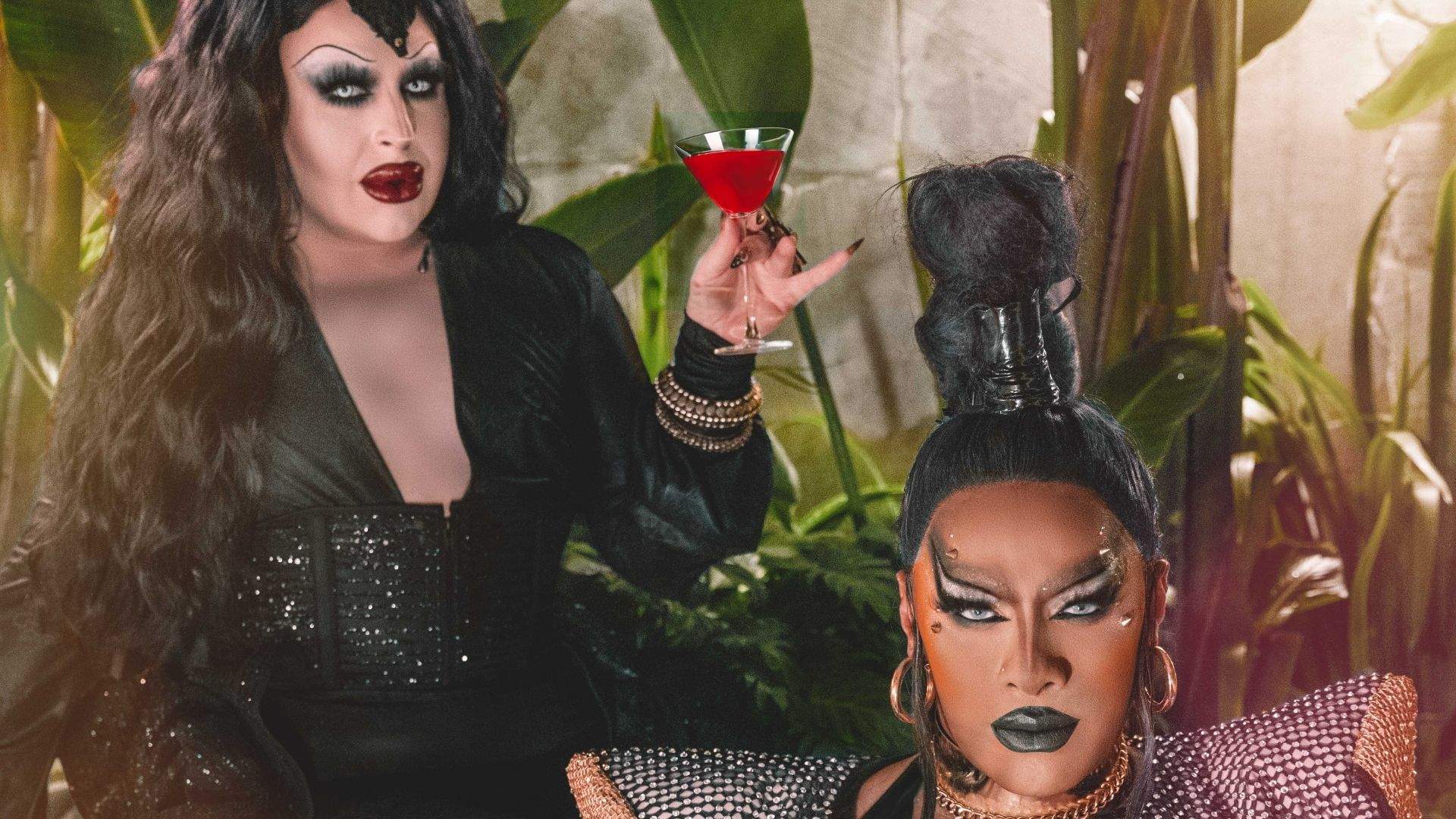 Drag queens in spooky attire for Halloween celebrations.