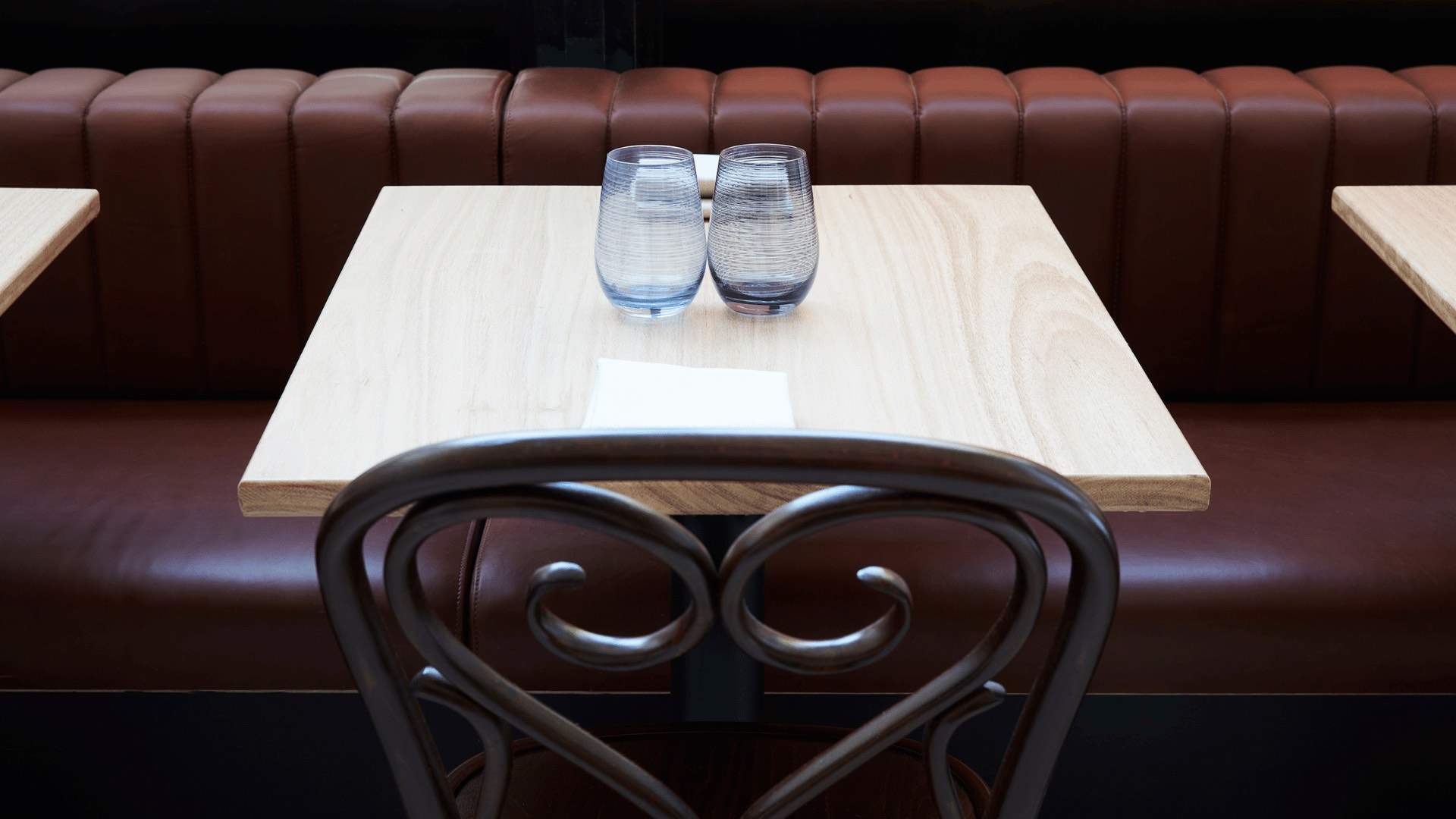 A photo of a table with two glasses on it at Khanaa.