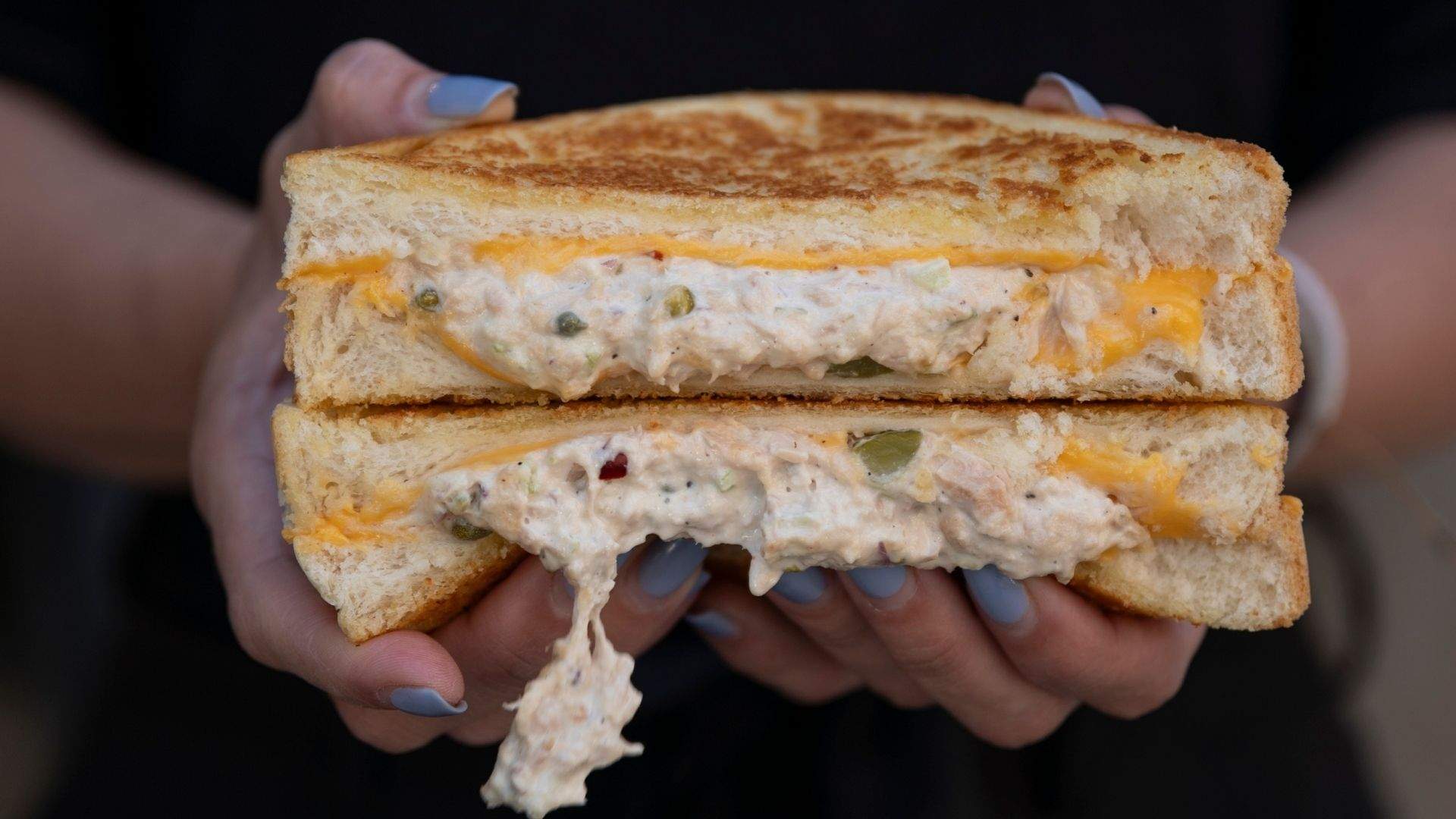 An elevated tuna melt, which packs a punch, boasting the familiar melted cheese and tuna paired with cornichons, capers and chilli sandwiched between two slices of thick white toast from Two Good Cafe Co's october menu by chef Mat Lindsay.